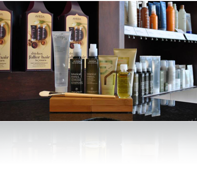 A counter with bottles of hair products on it.